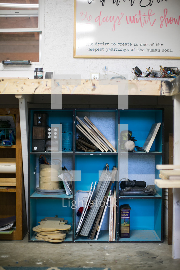 tools and wood on shelves in a workshop 