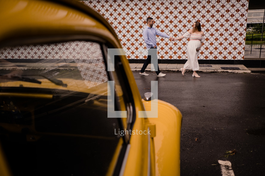 expecting couple portrait with Yellow car 