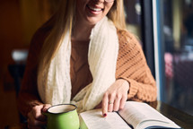 a woman reading a Bible over coffee