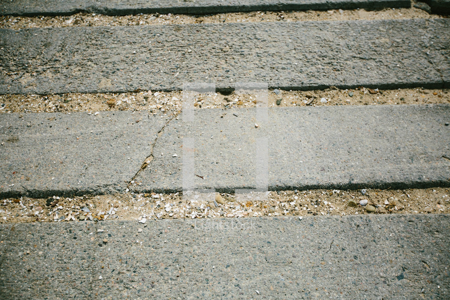 sandy spaces between concrete slabs 