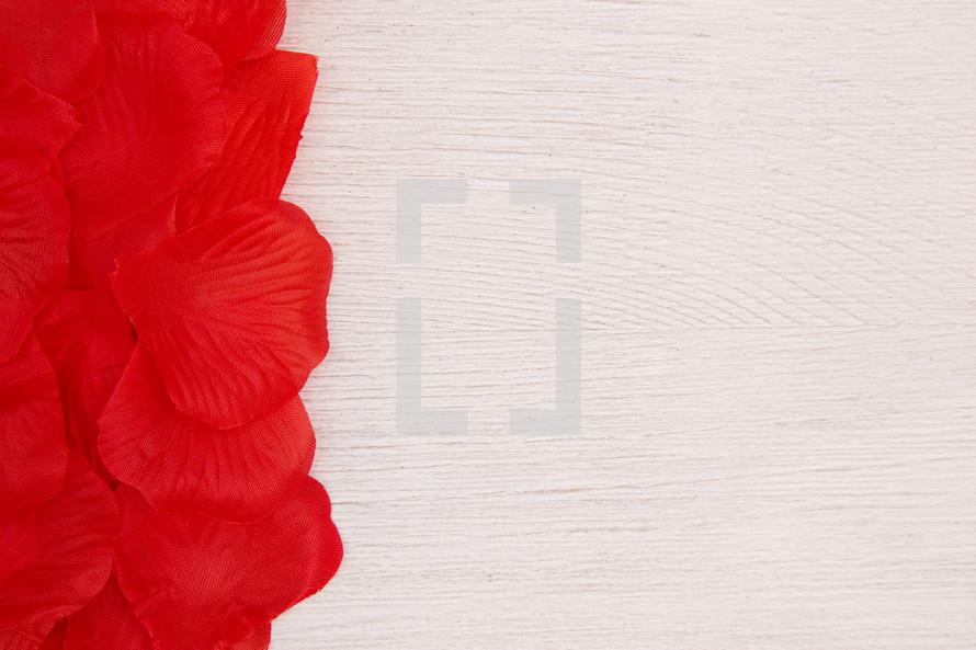 red petals on white wood 
