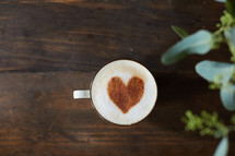 cinnamon heart in a coffee cup and house plant 
