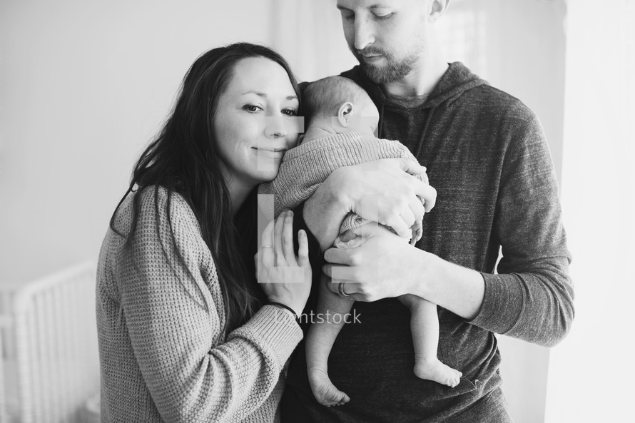 Parents holding their infant child.