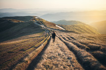 a girl standing on a mountaintop at sunrise 