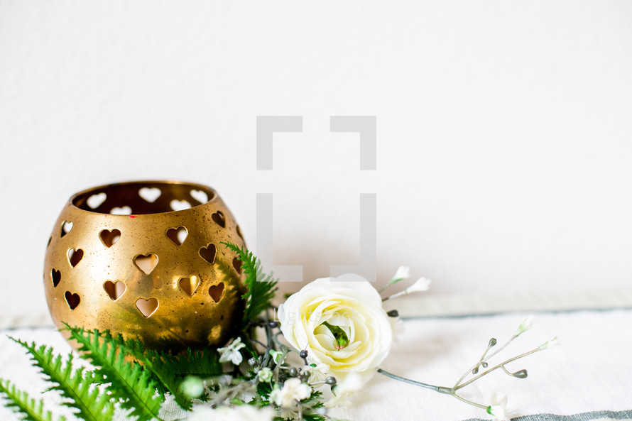 gold candle holder and flowers 