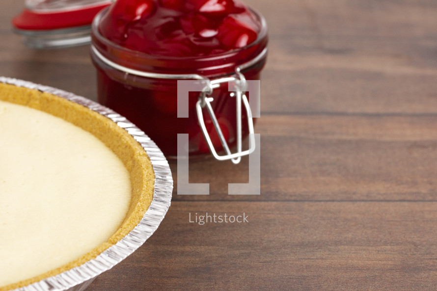 Thick Cherry Pie Filling in a Glass Canning Jar and cheesecake 