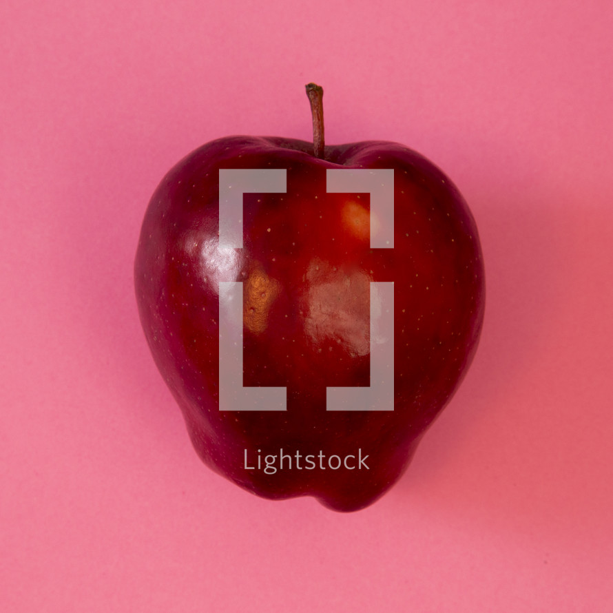 red apple on pink 