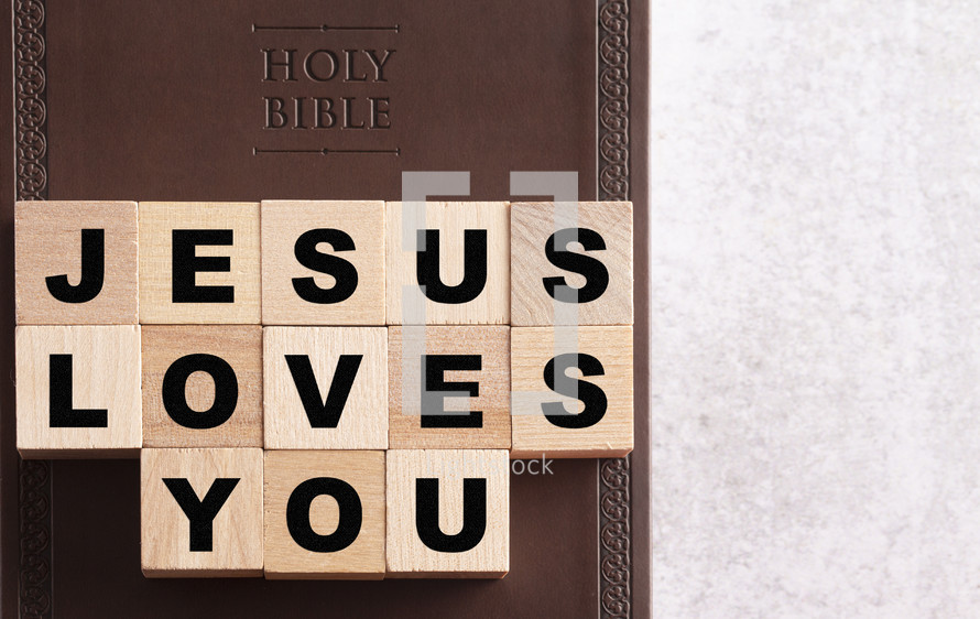 Holy Bible and words Jesus loves you 