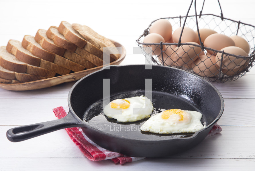fried eggs in a skillet 