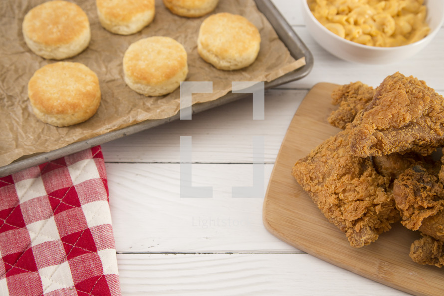 Classic Southern Fried Chicken and biscuits on a White Wood Table