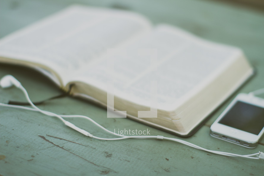 open Bible and an iPhone and earbuds 