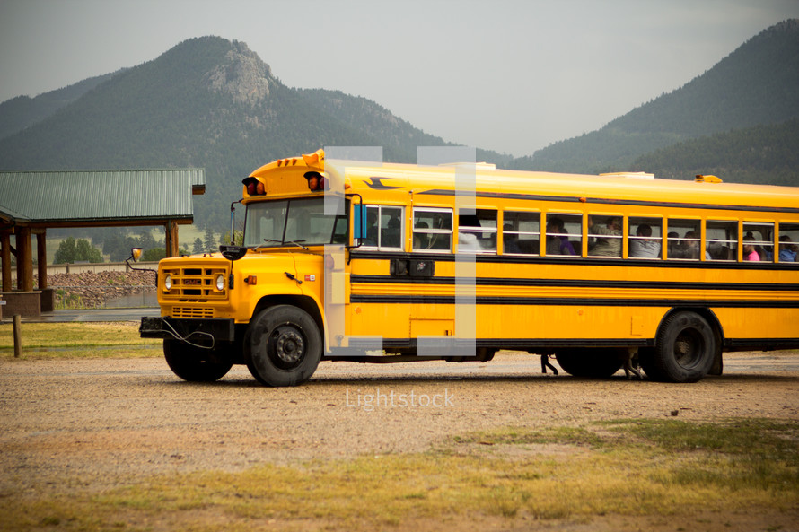 school bus parked at a lake 
