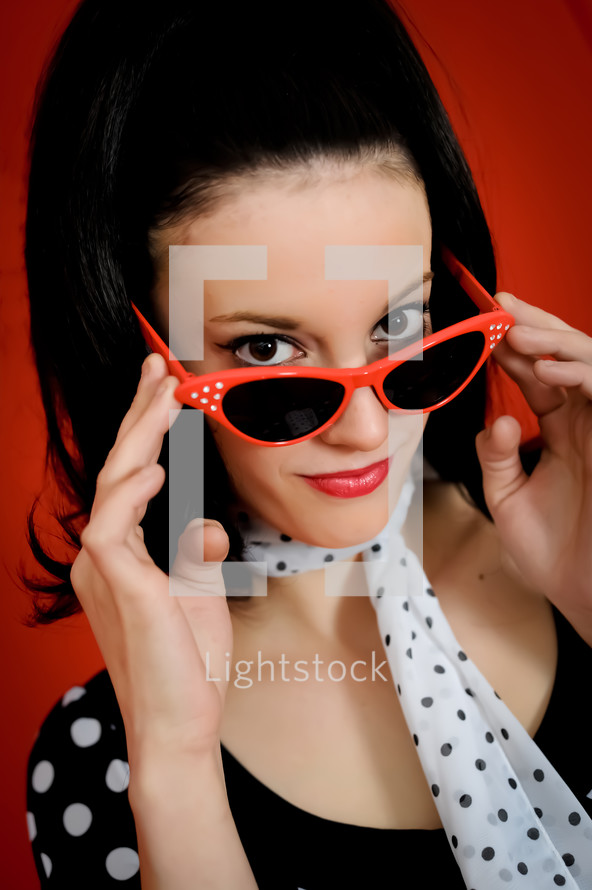 Woman looking over her cateye glasses.