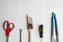 Tools lined up at the bottom of a white background.