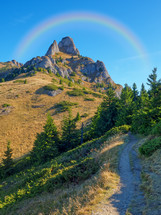 rainbow over a mountain peak