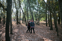 A couple in love standing in a forest. 
