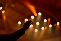 hand raised and stage lights 