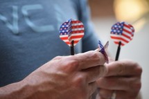 a man holding American flag darts 