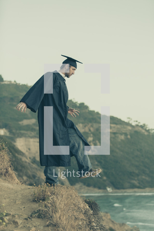 graduate stepping off a cliff