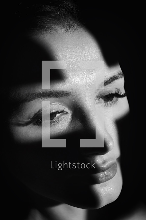 cross light shining on a woman's face 
