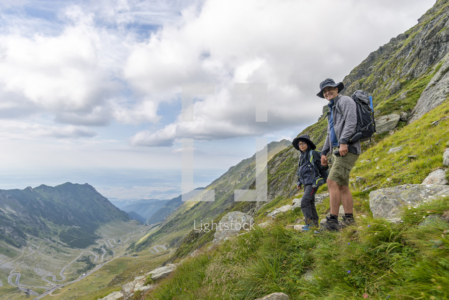 father and son hiking in the mountains 