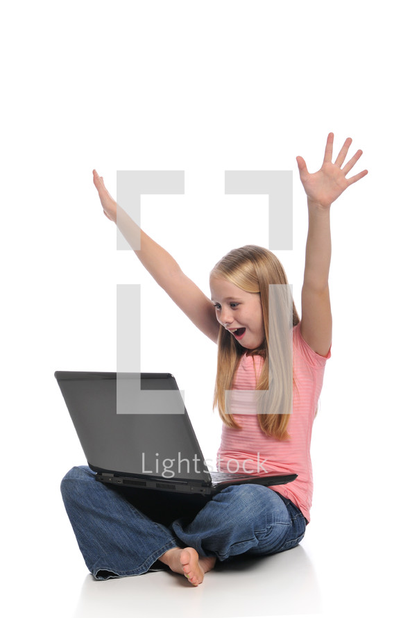 girl child on a laptop with raised hands 