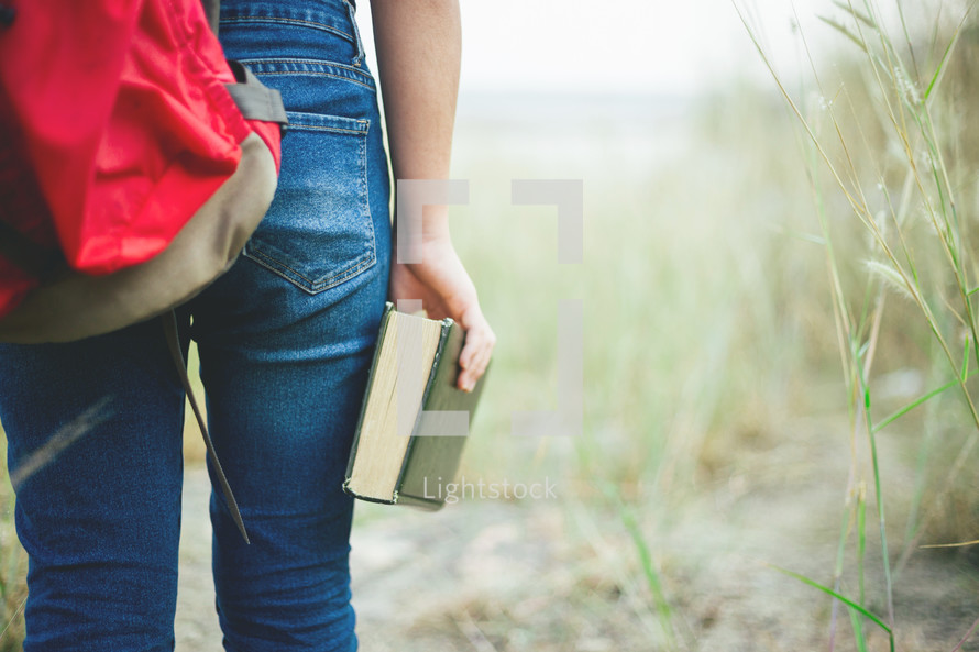 girl carrying a Bible 