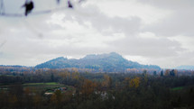 Wide shot of a mountain on a cloudy fall day. (He shall set me high upon a rock)