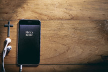 Bible app on a smartphone with earbuds 
