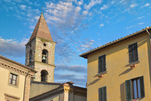 Close-up of colorful traditional italian buildings, bell tower and rooftops in a blue sunny day.