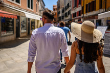 a couple walking hand in hand in Venice 