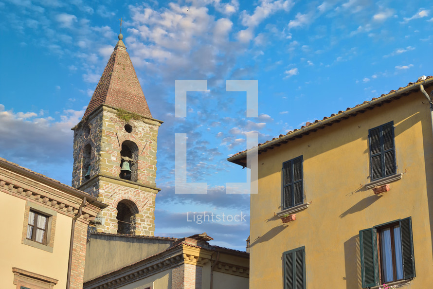 Close-up of colorful traditional italian buildings, bell tower and rooftops in a blue sunny day.