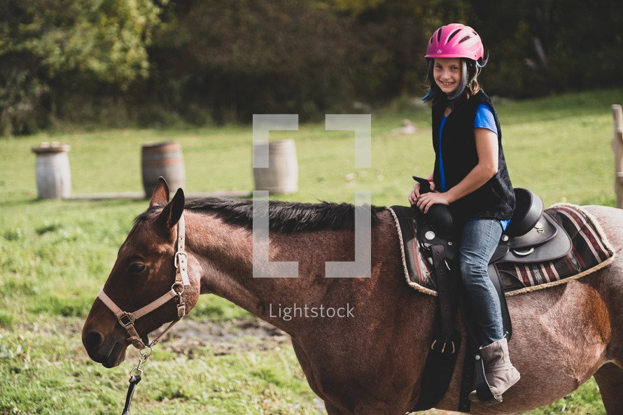 a girl riding a horse 