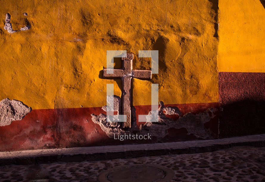 a cross embedded in a wall 