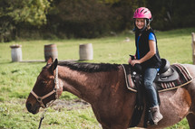 a girl riding a horse 