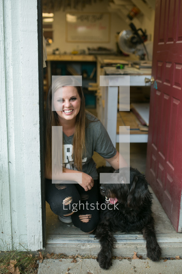 a woman in the doorway of a workshop 