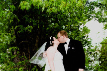 a bride and groom kissing 