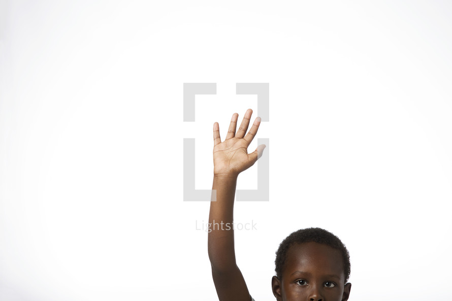 an African American boy with hand raised 