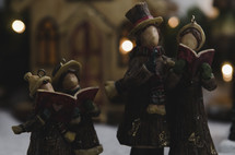 carolers in a Christmas village 