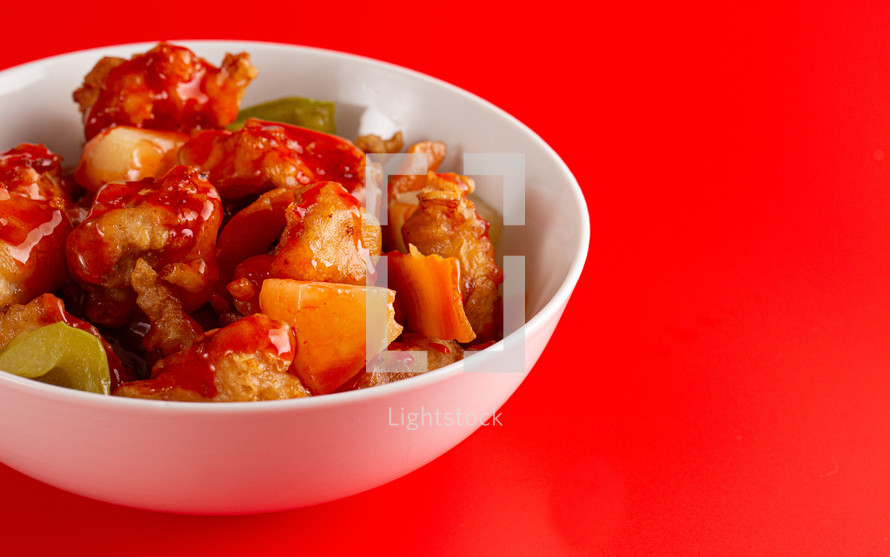 Bowl of Fried Chicken and Vegetables with Sweet and Sour Sauce