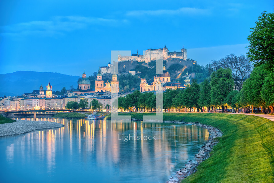 Festung Hohensalzburg fortress and reflection of night city lights. Austria