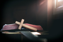 wooden cross and open Bible on a guitar 
