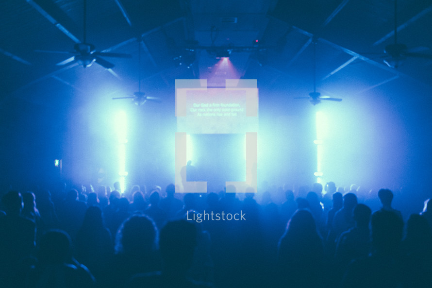 projection screen, contemporary worship service, raised hands, concert