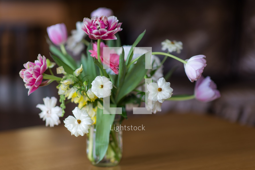 vase of flowers on a wood table 