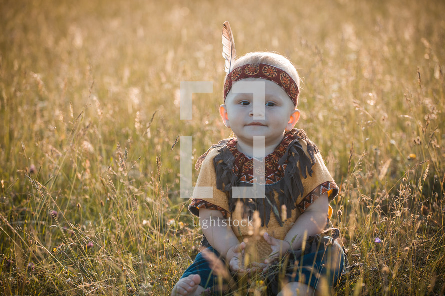 Happy Cute Smiling Little Boy dressed in Native American Apache Clothes 