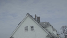 birds on the roof of a house 