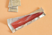 Abstract Chewing Gum Bacon In A Foil Wrapper