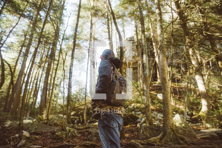 a man backpacking in a forest 