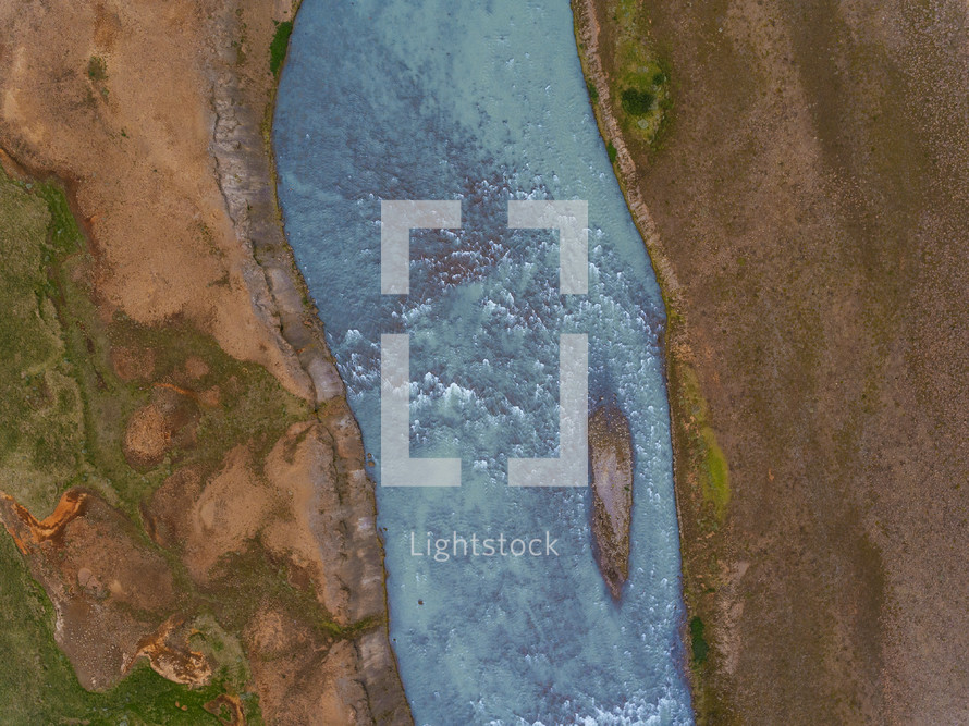 aerial view over a frozen river 