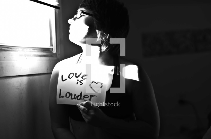 woman holding a sign - love is louder